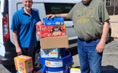 2 men from Forked River Presbyterian Church standing in from of a van with food donations for the Lacey food bank