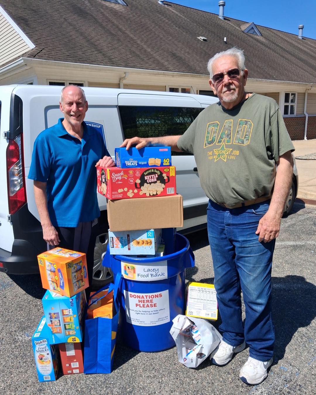 2 men from Forked River Presbyterian Church standing in from of a van with food donations for the Lacey food bank