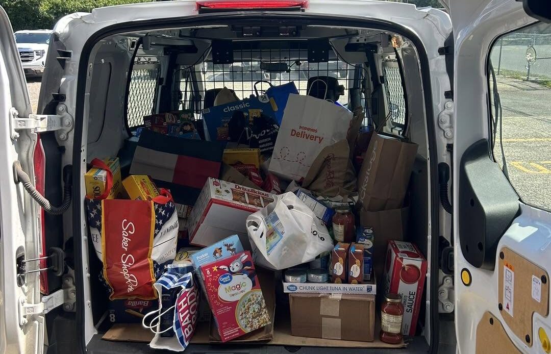 back of a white cargo van loaded with groceries for the lacey food bank