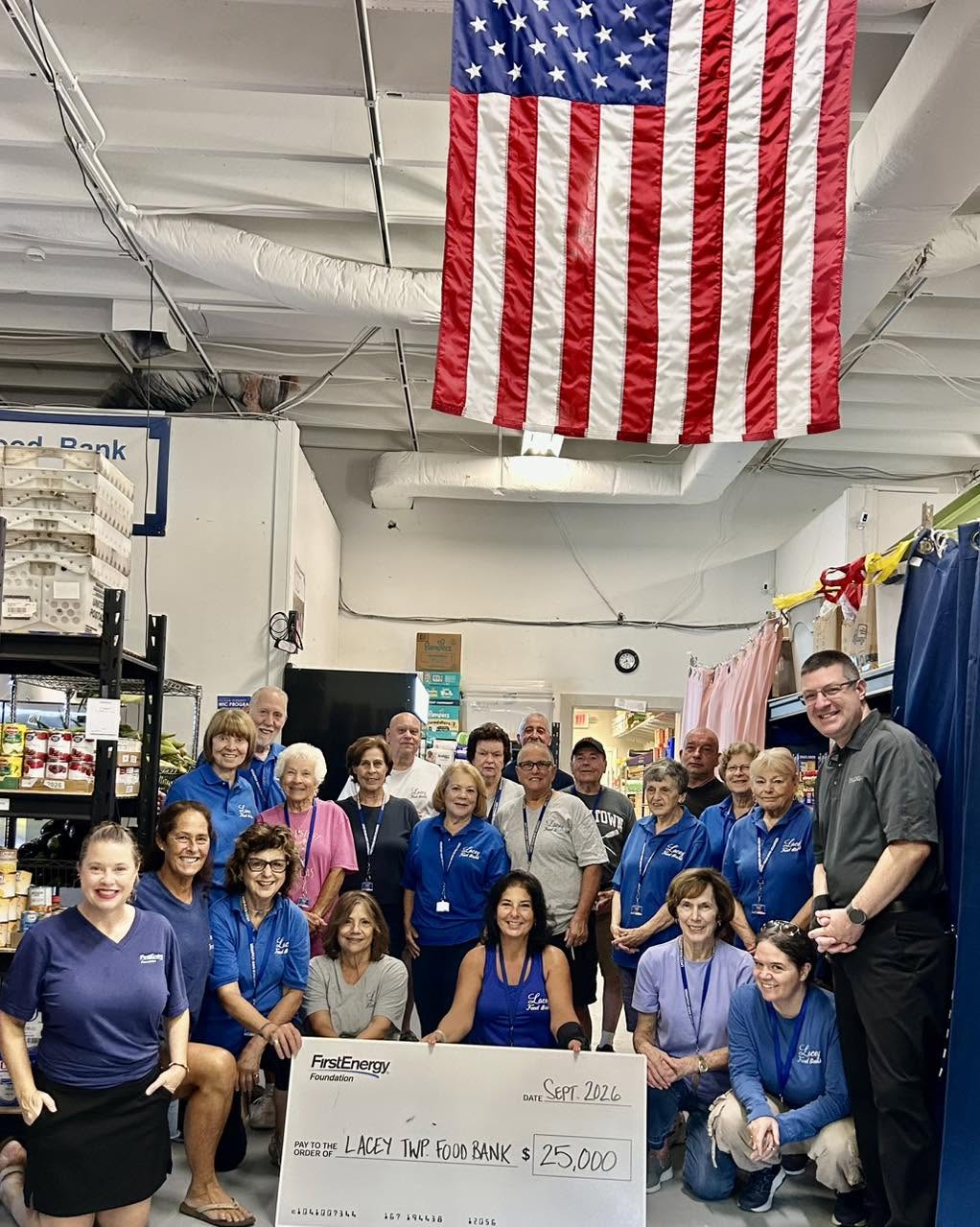 First energy Foundation presents a large $25,000 check to the Lacey Food Bank Volunteers