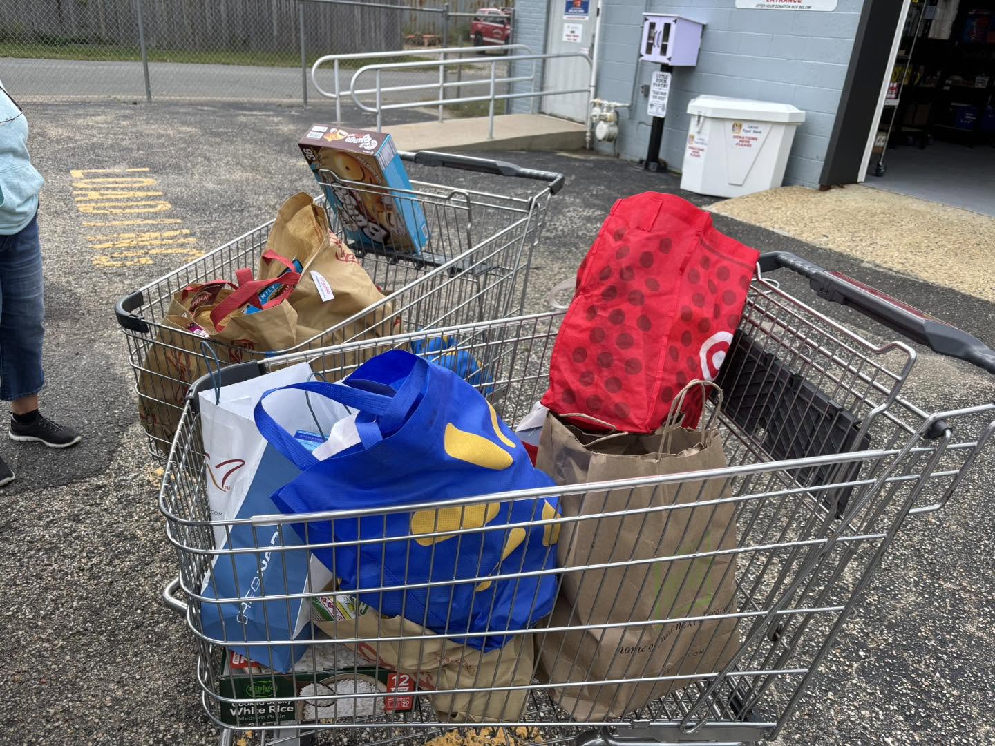 2 shopping carts with bags of food donations