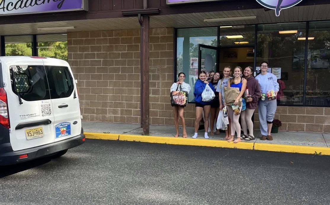 Trademark Dance Academy with Food Donations in front of dance school